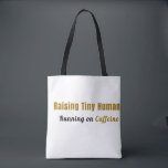 Raising Tiny Humans, Running on Caffeine Tote Bag<br><div class="desc">For the mom who carries it all with style. This "Raising Tiny Humans, Running on Caffeine" tote bag is perfect for busy moms who need a little extra space for all their essentials — and a constant reminder of the daily hustle. A modern, minimalist design that’s perfect for: • Groceries...</div>