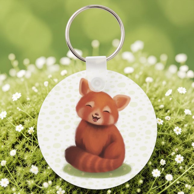 Red Panda Schlüsselanhänger (A keychain with a hand-painted red panda, cute and smiling, laid on sunlit moss.)