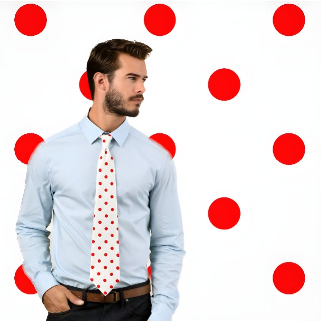 Red Polka Dot Pattern auf der weißen Krawatte (Man wears white necktie with red poka dots. He stands against a pokadot background.)