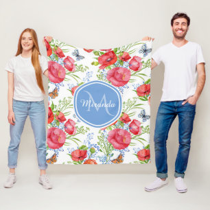 Reizende rote Mohnblumen mit blauen Fleecedecke