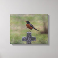 Robin auf einem Kreuz