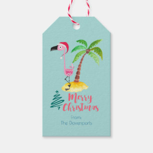 Rosa Flamingo in einer Weihnachtsmannmütze durch Geschenkanhänger