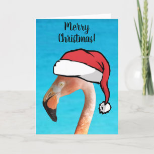 Rosa Flamingo mit roter Cartoon-Santa-Mütze Weihna Feiertagskarte