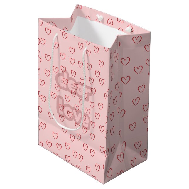 Rosa Geschenktüte mit Herz-Muster (Vorderseite Schrägansicht)