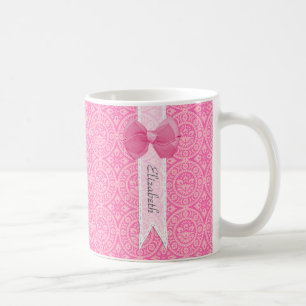 Rosa Spitzenmuster mit Band-Schleifendesign und Na Kaffeetasse