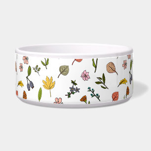 Rosa und gelbe Herbstblumen und Blätter Napf