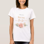 Rose Goldblume Eukalyptusgrün T-Shirt<br><div class="desc">Für ein Brautparty oder ein Bachelorette Wellness-Center und Wellness Wochenende. Ein schick weißer Hintergrund. Die Einrichtung besteht aus Rose Gold, Rosa Blüte, Blume (Rose) und grünen Eukalyptus-Blätter in Aquarellen, Zierpflanzen, Grünpflanzen und Imitaten mit goldenem Sprig. Personalisieren und fügen Sie den Namen der Braut. Schwarze und goldene Buchstaben. Mit dem Text:...</div>