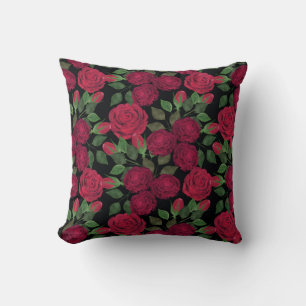 Rote Rosen auf schwarz. Kissen