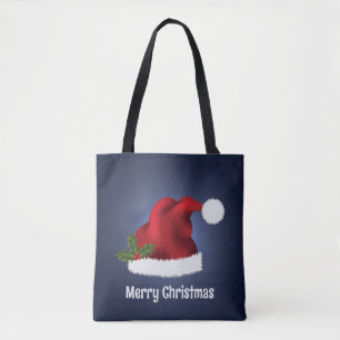 Rote Santa-Mütze mit Weihnachtsholly auf Blau