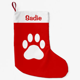 Rote und weiße Silhouette einer Hundepfote mit ind Kleiner Weihnachtsstrumpf
