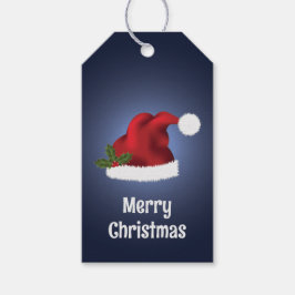 Rote Weihnachtsmannmütze mit Weihnachts-Holly auf  Geschenkanhänger