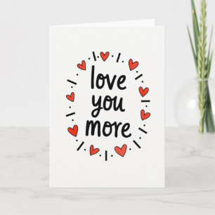 Roter Liebeskarten mit 'Ich liebe dich mehr'-Text Karte
