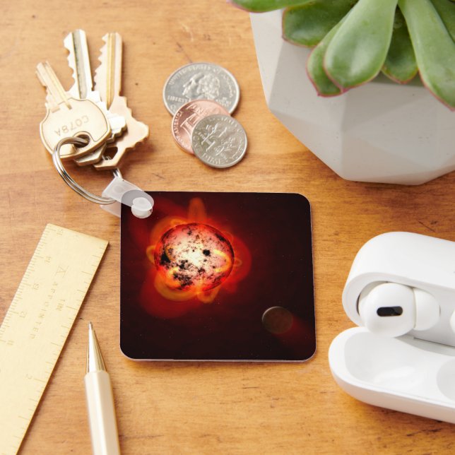 Roter Zwergstern, der von einem hypothetischen Exo Schlüsselanhänger (Schreibtisch)