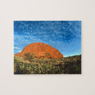 Rotes Leuchten des berühmten Ayers Rock im Outback Puzzle
