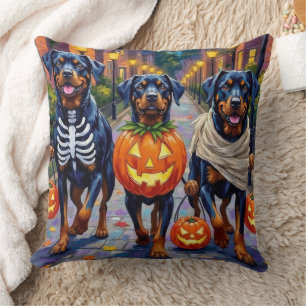 Rottweiler, die an Halloween in Kostümen Süßigkeit Kissen
