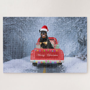 Rottweiler-Hund im Schnee sitzt im Weihnachts-LKW  Puzzle