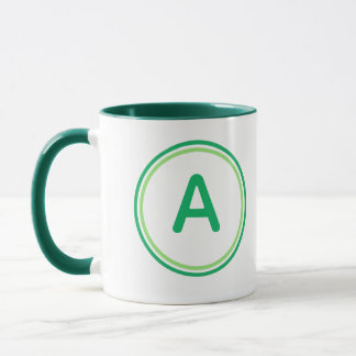 Rundes Buchstabenalphabet Grünkreis-Design Tasse