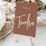 Rust Hand Scripted Table TWELVE Tischnummer<br><div class="desc">Einfache und schicke Tischnummer-Karten im Erdton Rost braun und Weiß machen eine elegante Aussage bei Ihrer Hochzeit oder Veranstaltung. Das Design bietet "table [number]" in einem spannenden Mix aus klassischen Serifen und handgeschriebenen Skripten. Design wiederholt sich auf beiden Seiten. Einzelne nummerierte Karten werden separat verkauft; bestellen Sie jede Tischnummer einzeln...</div>