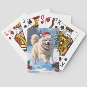 Samojede läuft im Schnee mit Weihnachtsmütze Spielkarten