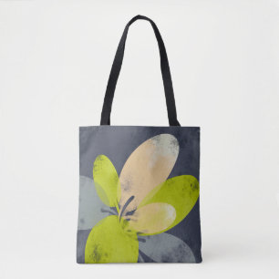 Sanfte gelbe Blüte auf grauer Tote-Tasche