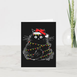 Santa Black Cat hallte in Weihnachtsbaumlicht auf Karte