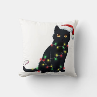 Santa Black Cat hallte in Weihnachtsbaumlicht auf Kissen