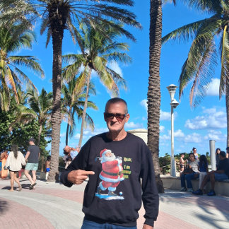 Santa Claus relaxes before the Christmas on a Grey Sweatshirt