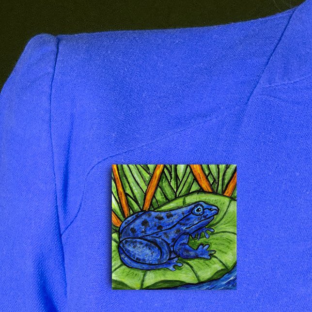 Schaltfläche "Blauer Giftfrosch" Button (Vibrant blue frog on green lily pad in water with grass and reed plants on square pin back button.)