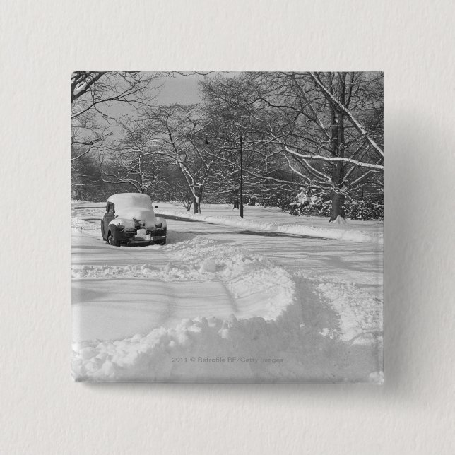 Schnee mit einer Kappe bedecktes Auto auf Straße Button (Vorderseite)