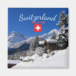 Schneebedeckte Blockhütten in der Schweiz Magnet