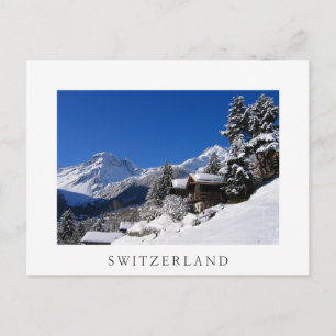 Schneebedeckte Blockhütten in der Schweiz Postkarte