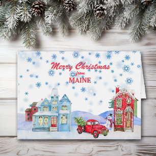 Schneebedecktes Dorf auf einer Maine-Weihnachtskar