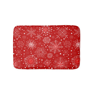 Schneeflocken auf rotem Hintergrund Badematte