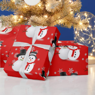 Schneemann auf rotem Weihnachts-Handwerk oder Geschenkpapier
