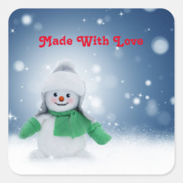 Schneemann mit grünem Schal Quadratischer Aufkleber