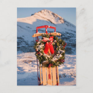 Schneeschlitten mit Weihnachtskranz Feiertagspostkarte