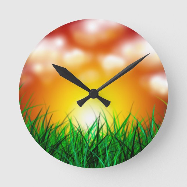 Schöner Sonnenaufgang über einem Grasfeld Runde Wanduhr (Vorderseite)
