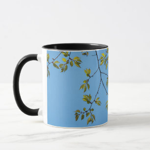 schöner Zweig mit grünen und gelben Blätter umarme Tasse