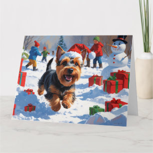 Schottischer Terrier läuft durch Schnee mit Weihna Karte