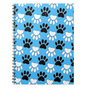 Schwarz-Weiß-Pfoten auf blauem Hintergrund Notizblock