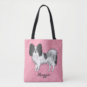 Schwarz-weißer Papillon-Hund auf rosa Herzen