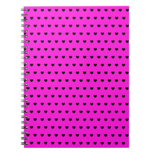 Schwarze Herzen auf leuchtend rosa Notebook Notizblock