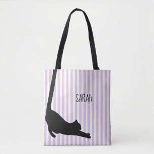 Schwarze Katze mit langen Schwänzen über die Tasch