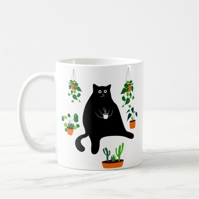 Schwarze Katze mit Pflanze, lustiges schwarzes Kat Kaffeetasse (Links)