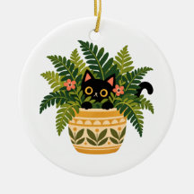 Schwarze Katze schaut aus botanischem Pflanzkübel
