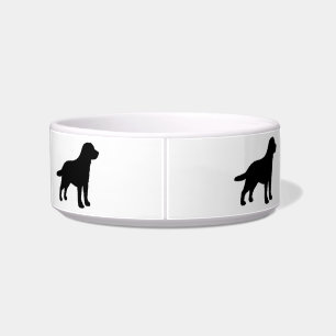 Schwarze Labrador-HundeSilhouetten auf Napf