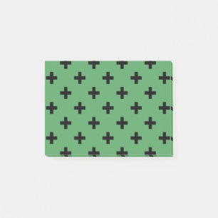Schwarze Polka kreuzt grün Post-it Klebezettel