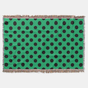 Schwarze Polka Punkte auf frisch grünem Decke