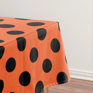 Schwarze Polka-Punkte auf Orange Tischdecke