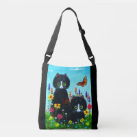 Schwarze Tuxedokatzen und farbenfrohe Blume